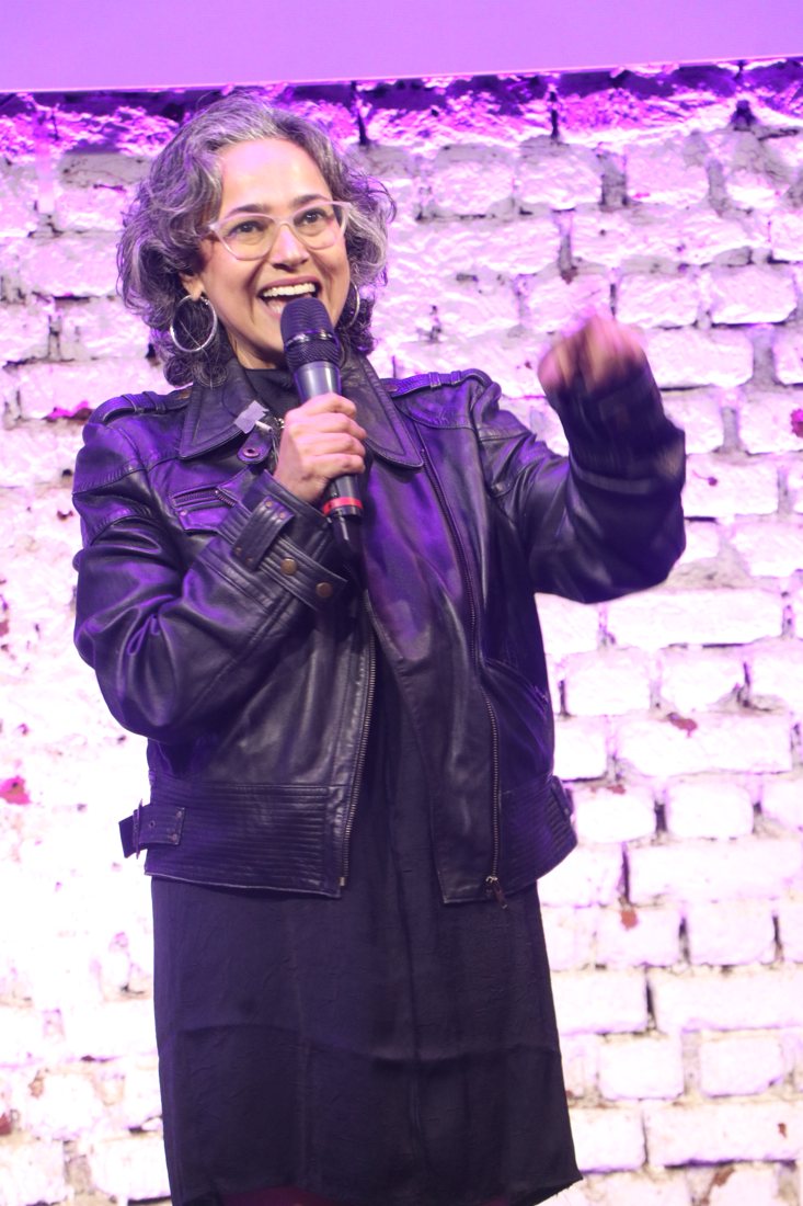 Komal speaking on stage