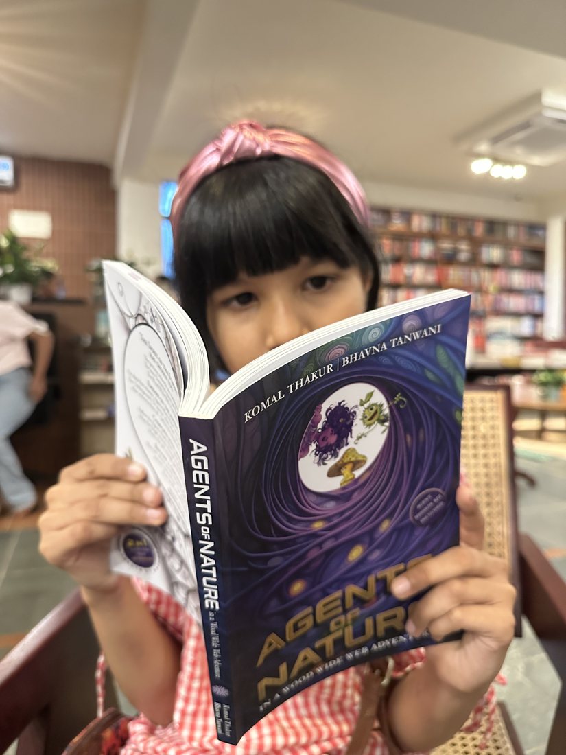 A young reader inside the book at a bookstore