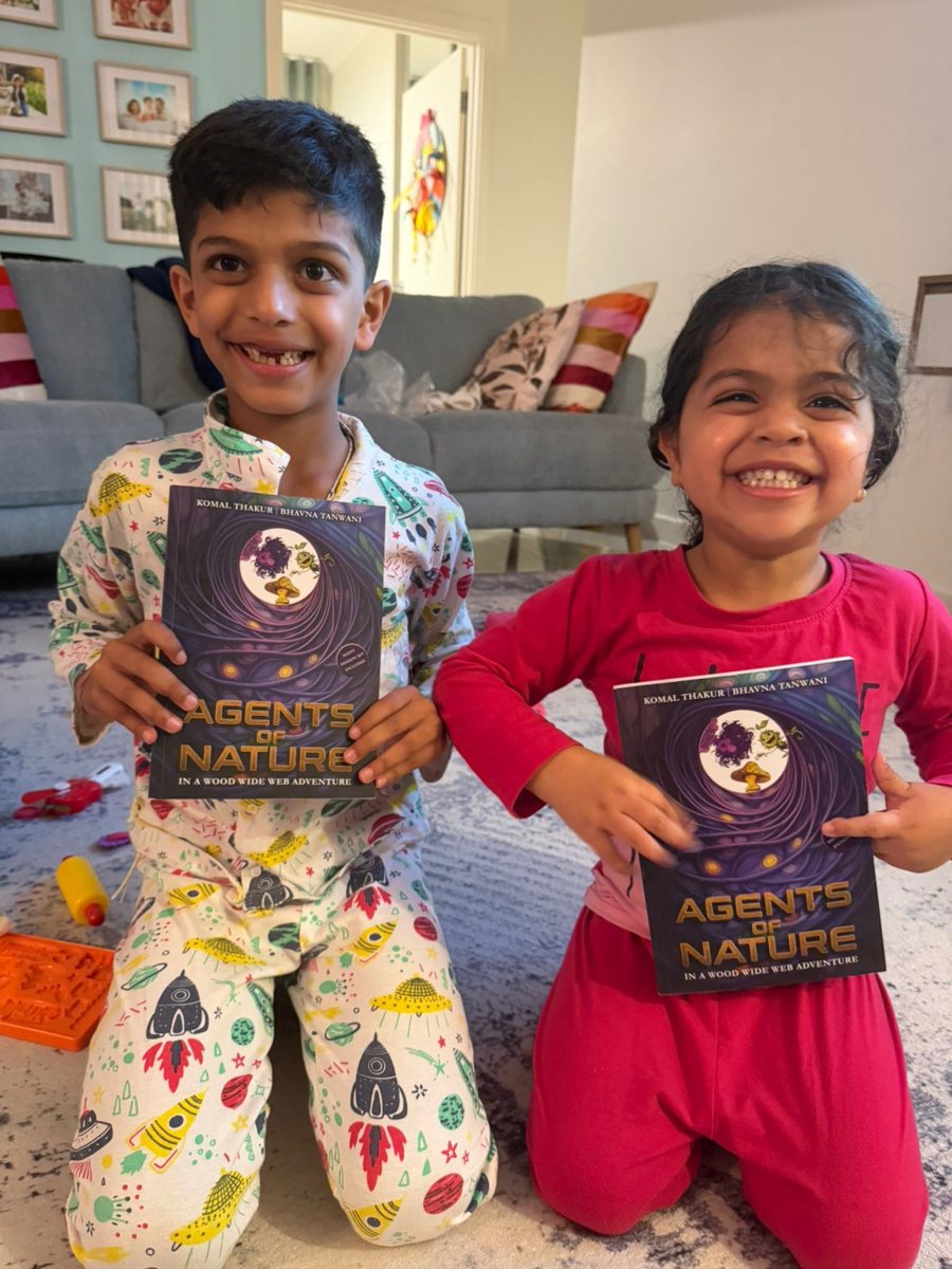 Two young Agents holding their copies of Agents of Nature